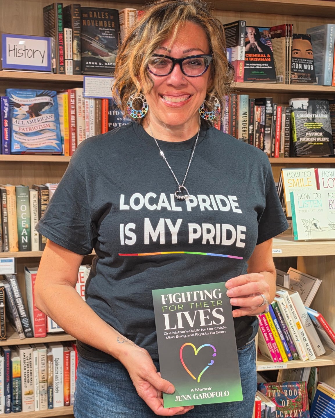 Jenn Garofolo holding Fighting for Their Lives at a Pride event at Ten Trees Books in Natick